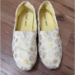 Toms gold/white slip on shoes, size 8